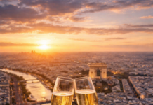 Drinking a glass of champagne at the top of the Eiffel Tower